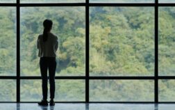 Businesswoman walk to the glass window Businesswoman walk to the glass window