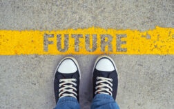 Step into the future. Male sneakers on the asphalt road with yellow line and title Future. Step into the future.